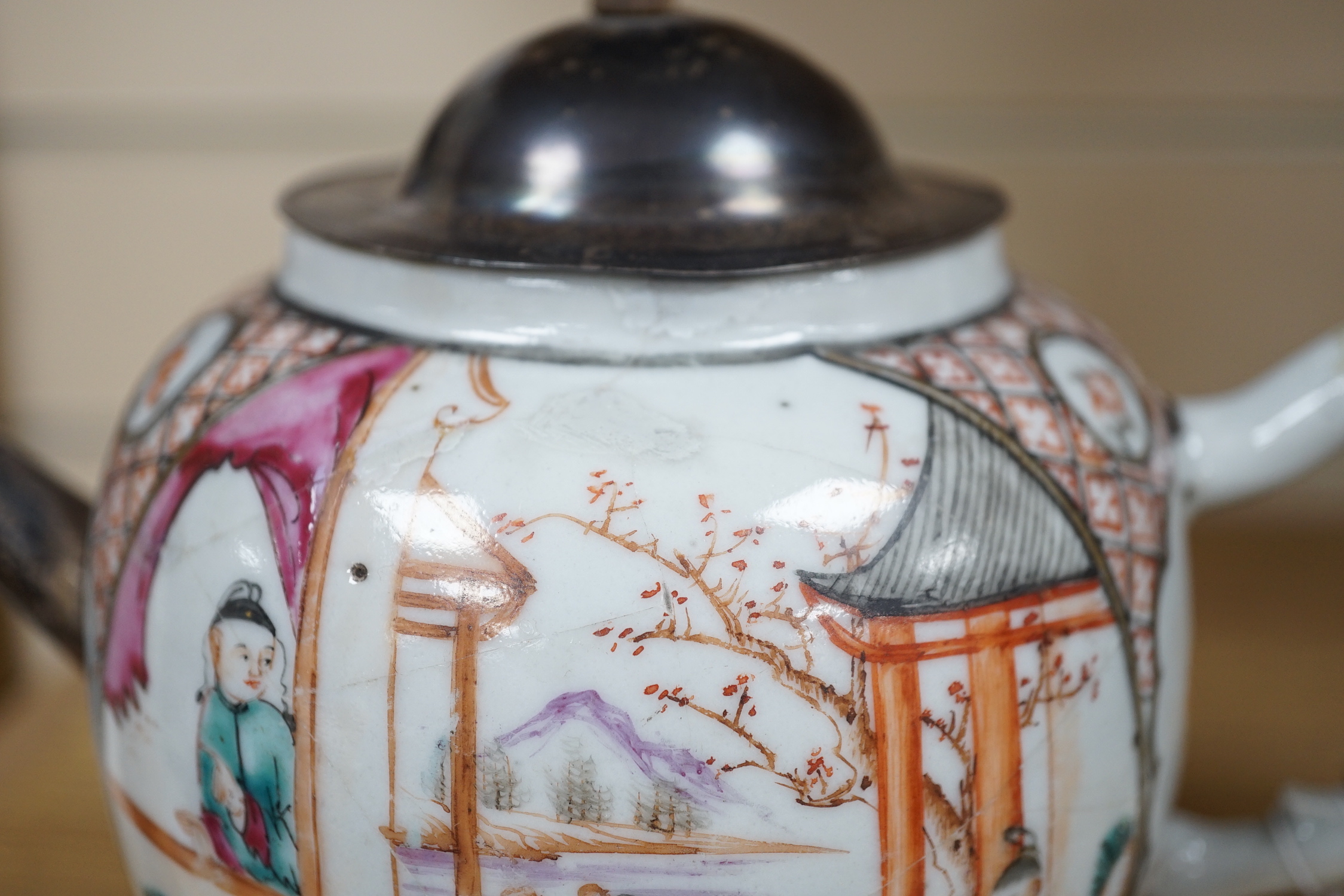 An 18th century Chinese export famille rose teapot with later silver spout and cover, on hardwood stand